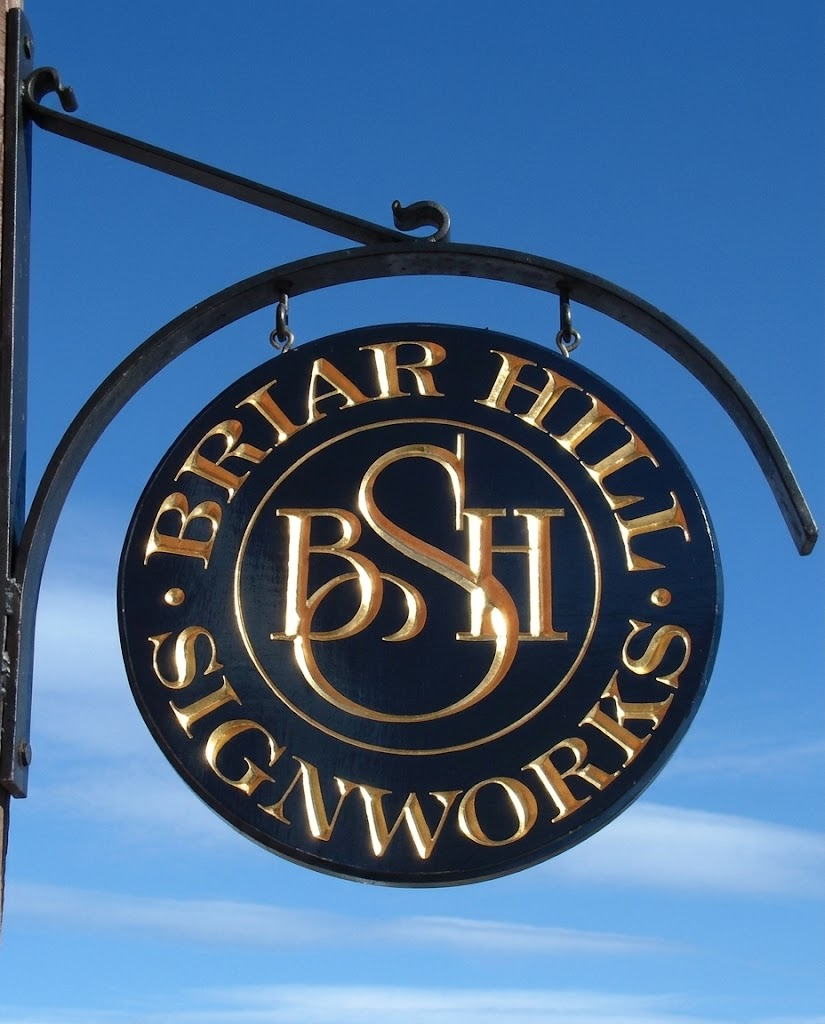 Briar Hill Signworks hanging sign against a blue sky